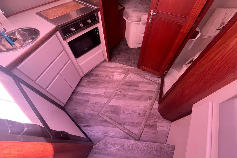Slide: The Image of Interior of 1992 Carver 33 Aft Cabin Motor Yacht with kitchen and wood flooring. - 22