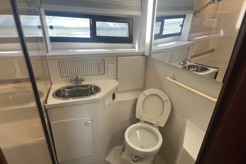 Slide: The Image of Bathroom interior of 1992 Carver 33 Aft Cabin Motor Yacht with sink and toilet. - 33
