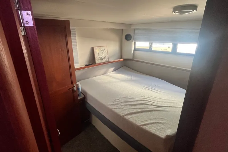 Slide: The Image of Cozy bedroom in 1992 Carver 33 Aft Cabin Motor Yacht with natural light. - 32