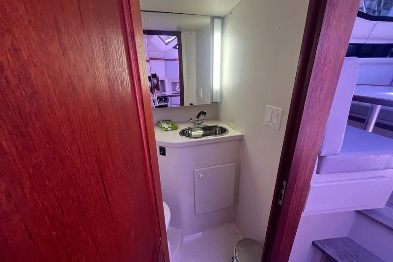 Slide: The Image of Interior of 1992 Carver 33 Aft Cabin Motor Yacht bathroom with sink and mirror. - 25
