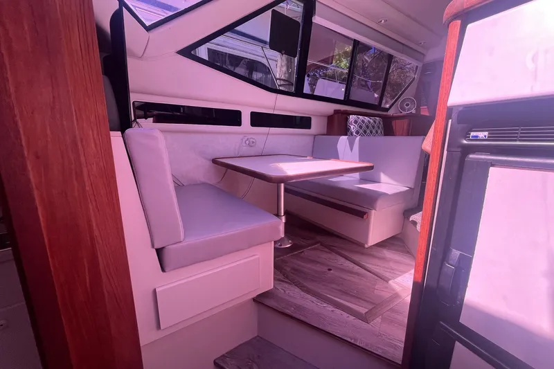 Slide: The Image of Interior of 1992 Carver 33 Aft Cabin Motor Yacht with dining area and seating. - 23