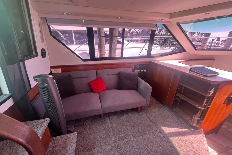 Slide: The Image of Interior of 1992 Carver 33 Aft Cabin Motor Yacht with sofa and panoramic windows. - 17