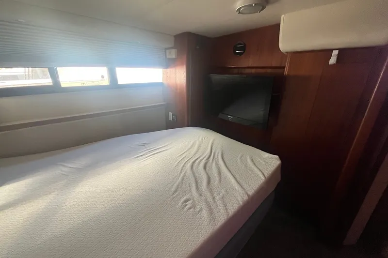 Slide: The Image of Interior cabin of 1992 Carver 33 Aft Cabin Motor Yacht with bed and TV. - 35