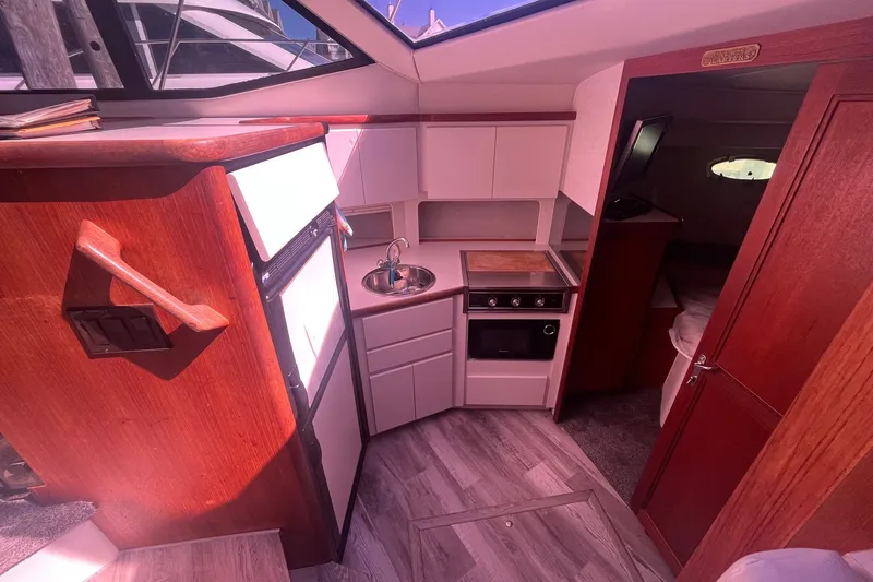 Slide: The Image of Interior of 1992 Carver 33 Aft Cabin Motor Yacht with compact kitchen area. - 21