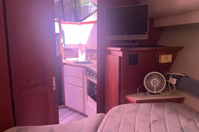 Slide: The Image of Interior of 1992 Carver 33 Aft Cabin Motor Yacht with kitchenette and TV. - 30