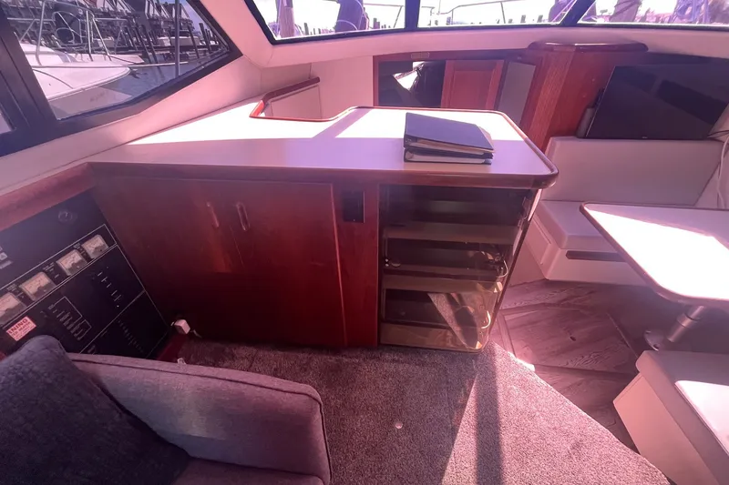 Slide: The Image of Interior of 1992 Carver 33 Aft Cabin Motor Yacht with wooden cabinetry and seating area. - 19