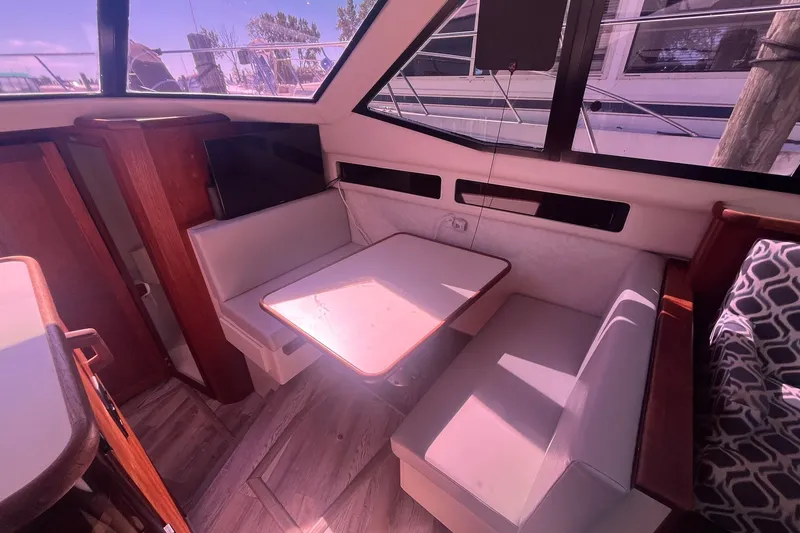Slide: The Image of Interior of 1992 Carver 33 Aft Cabin Motor Yacht with dining area and seating. - 20