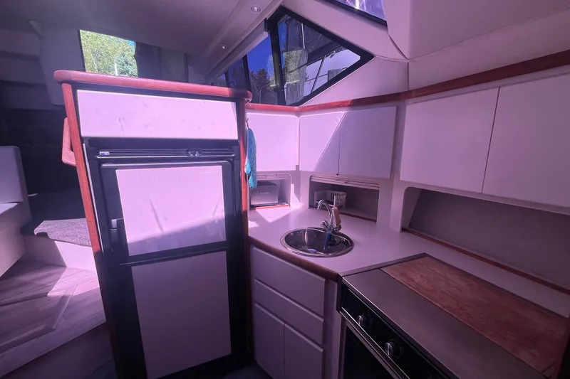 Slide: The Image of Interior of 1992 Carver 33 Aft Cabin Motor Yacht kitchen with sink and cabinets. - 28