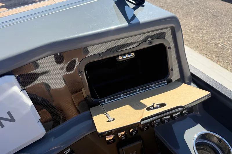 Slide: The Image of Dashboard of Whisper RLS 23V 2027 with open storage compartment and USB port. - 15