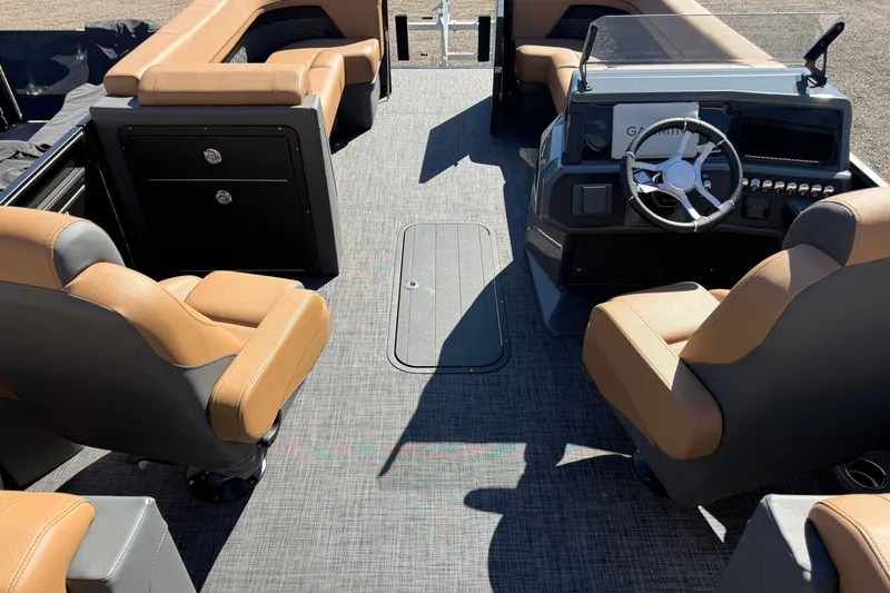 Slide: The Image of Interior of 2027 Whisper RLS 23V boat with tan seating and modern dashboard. - 18