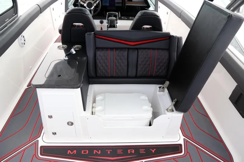 Slide: The Image of 2027 Monterey Elite 30 OB boat interior with seating, sink, and storage compartment. - 11