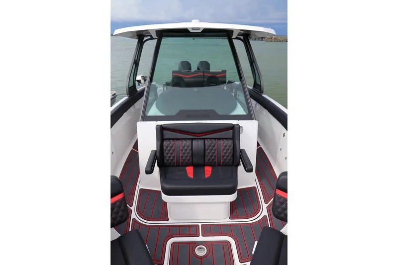 Slide: The Image of 2027 Monterey Elite 30 OB boat interior with sleek black and red seating design. - 4