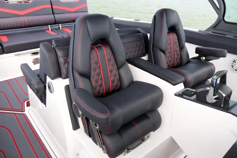 Slide: The Image of Luxurious seating on 2027 Monterey Elite 30 OB boat with black and red accents. - 9