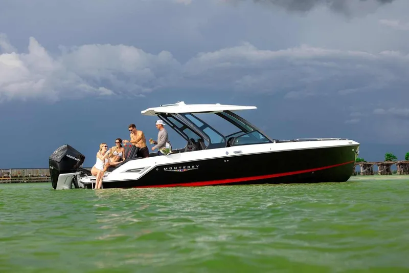 Slide: The Image of 2027 Monterey Elite 30 OB boat with people enjoying a day on the water. - 17