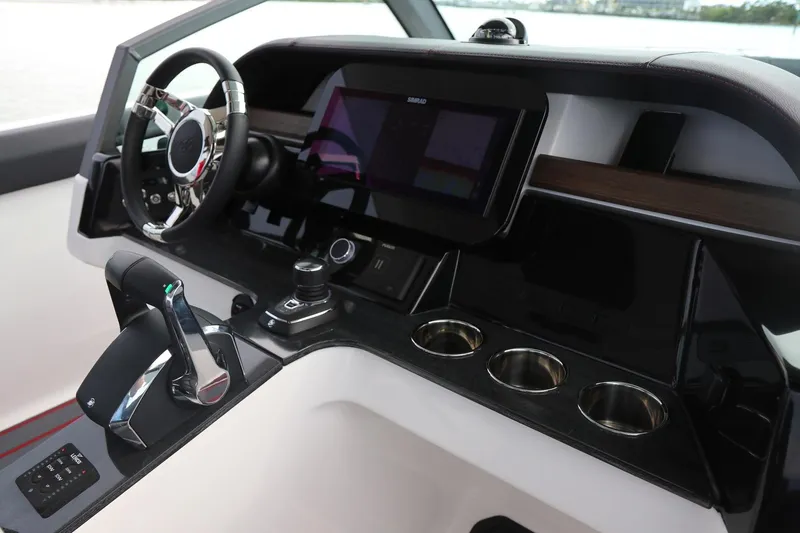 Slide: The Image of Helm of 2027 Monterey Elite 30 OB boat with modern controls and touchscreen display. - 8
