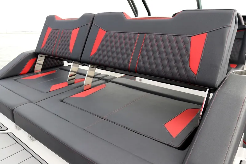 Slide: The Image of Luxurious seating on 2027 Monterey Elite 30 OB boat with red and black upholstery. - 14