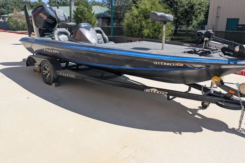 Slide: The Image of 2018 Falcon F205 boat on trailer, parked outdoors, featuring sleek design and powerful engine. - 4