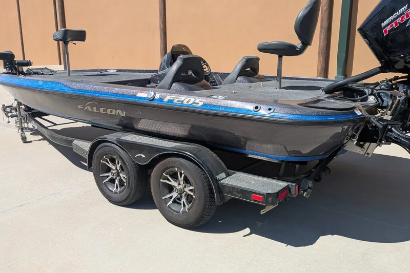 Slide: The Image of 2018 Falcon F205 boat on trailer, featuring sleek design and dual seats. - 2