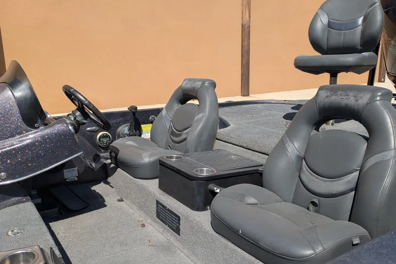 Slide: The Image of 2018 Falcon F205 boat interior with gray seats and steering wheel. - 6
