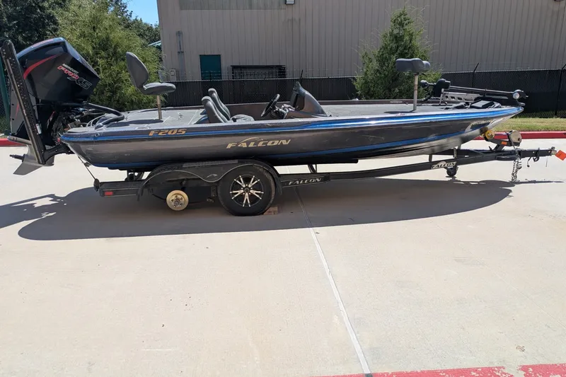 Slide: The Image of 2018 Falcon F205 boat on trailer, parked outdoors in sunny setting. - 11