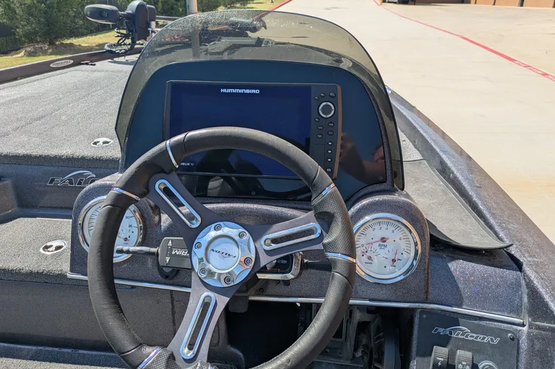 Slide: The Image of Cockpit view of a 2018 Falcon F205 boat with steering wheel and Humminbird display. - 8
