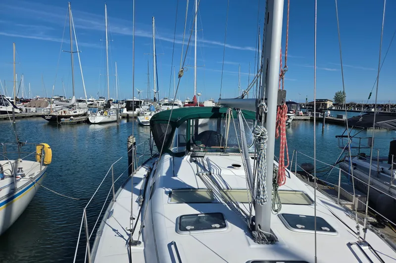 Slide: The Image of 2004 Beneteau Oceanis 393 sailboat docked in a marina under clear blue skies. - 5