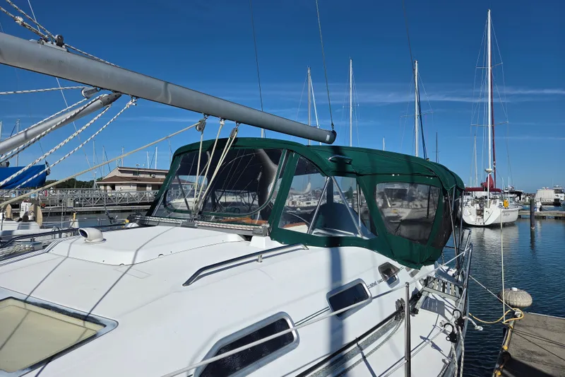 Slide: The Image of 2004 Beneteau Oceanis 393 sailboat docked at marina under clear blue sky. - 4