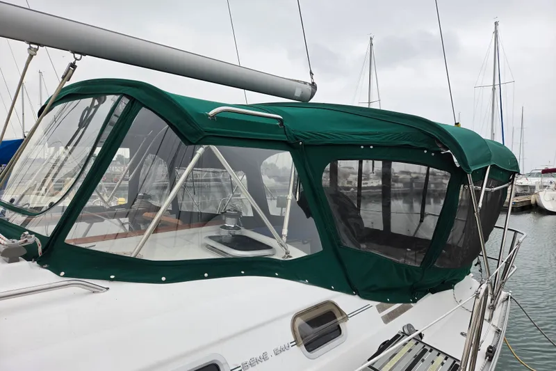 Slide: The Image of 2004 Beneteau Oceanis 393 sailboat with green canopy docked in marina. - 6