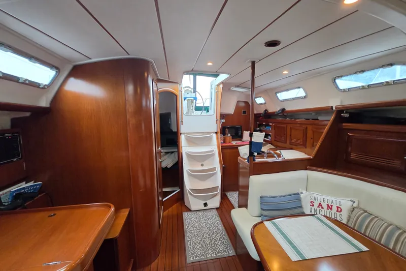Slide: The Image of Interior of 2004 Beneteau Oceanis 393 sailboat with wood finish and cozy seating area. - 11