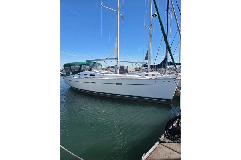 Slide: The Image of 2004 Beneteau Oceanis 393 sailboat docked in marina under clear blue sky. - 2