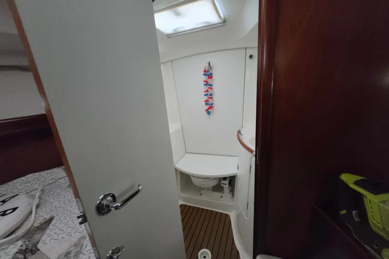 Slide: The Image of Interior view of 2004 Beneteau Oceanis 393 yacht bathroom with wooden accents. - 17