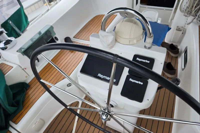 Slide: The Image of Steering wheel and controls of a 2004 Beneteau Oceanis 393 sailboat cockpit. - 9