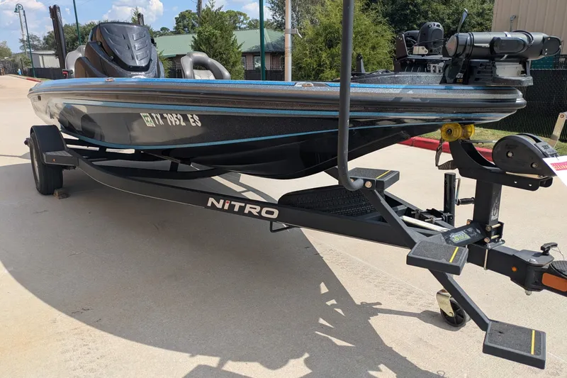 Slide: The Image of 2019 Nitro Z18 boat on trailer, parked outdoors, showcasing sleek design and branding. - 5