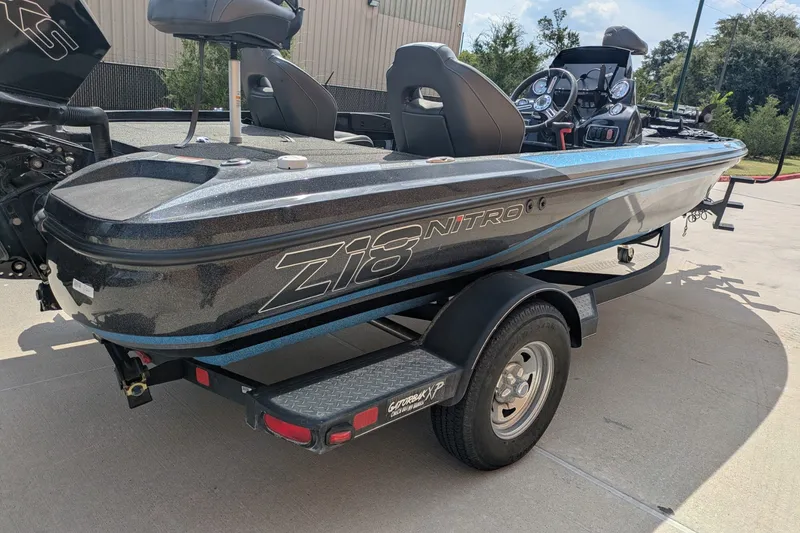 Slide: The Image of 2019 Nitro Z18 boat on trailer, featuring sleek design and modern seating. - 4