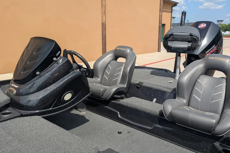 Slide: The Image of 2019 Nitro Z18 boat interior with steering console and cushioned seats. - 8