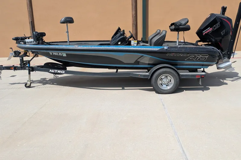 Slide: The Image of 2019 Nitro Z18 fishing boat on trailer, side view, parked outdoors. - 1