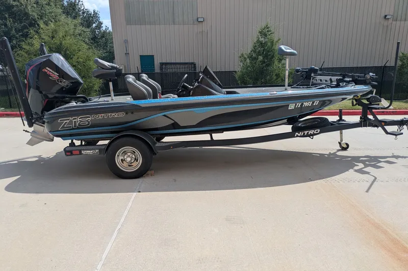 The Image of 2019 Nitro Z18 boat on trailer, parked outdoors, featuring sleek design and powerful engine. - 0