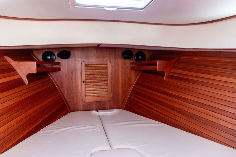 Slide: The Image of Interior of 2017 Hinckley Picnic Boat 37 MKIII with wood paneling and cushioned seating. - 13