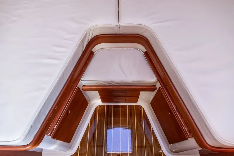 Slide: The Image of Interior view of 2017 Hinckley Picnic Boat 37 MKIII with wooden accents and white cushions. - 14