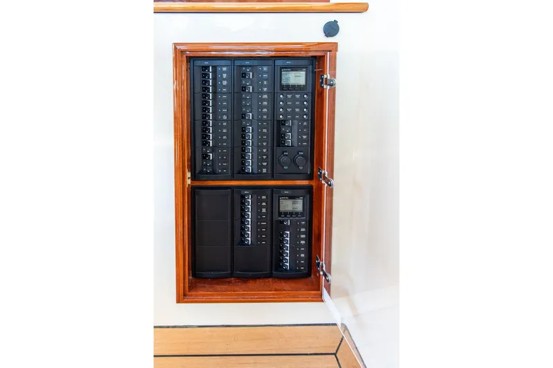 Slide: The Image of Electrical panel inside a 2017 Hinckley Picnic Boat 37 MKIII, featuring control switches and displays. - 18
