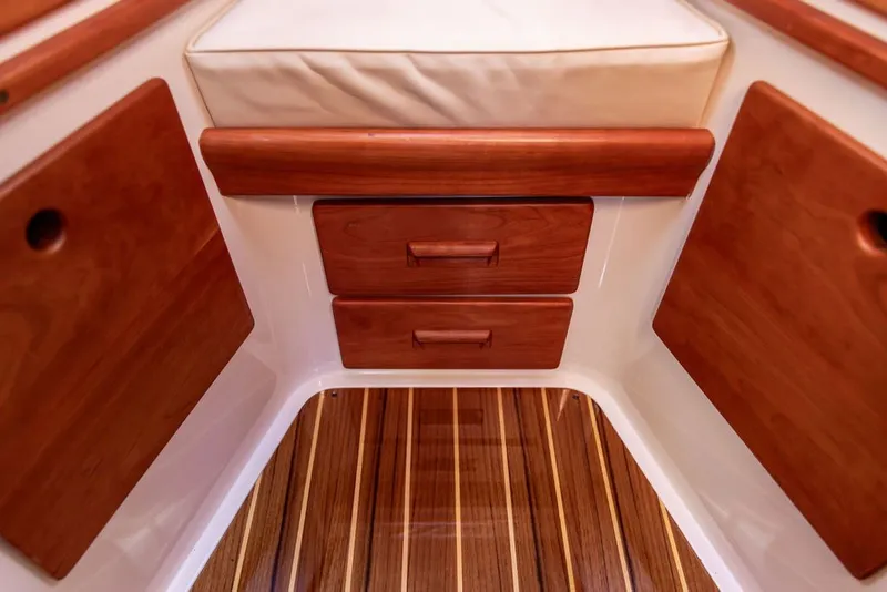 Slide: The Image of Interior of 2017 Hinckley Picnic Boat 37 MKIII with wooden cabinetry and striped flooring. - 15