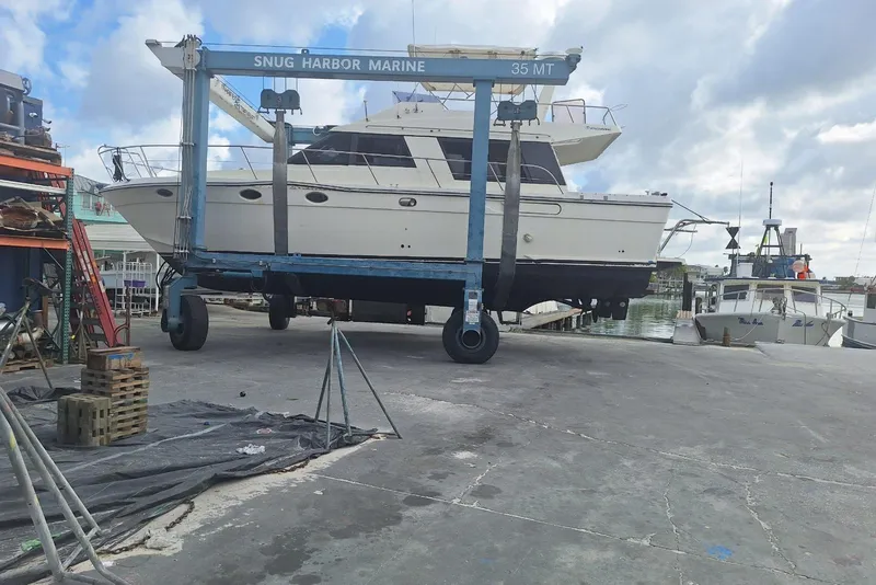 Slide: The Image of 1988 Birchwood 44TS yacht lifted at Snug Harbor Marine, dockside view. - 47