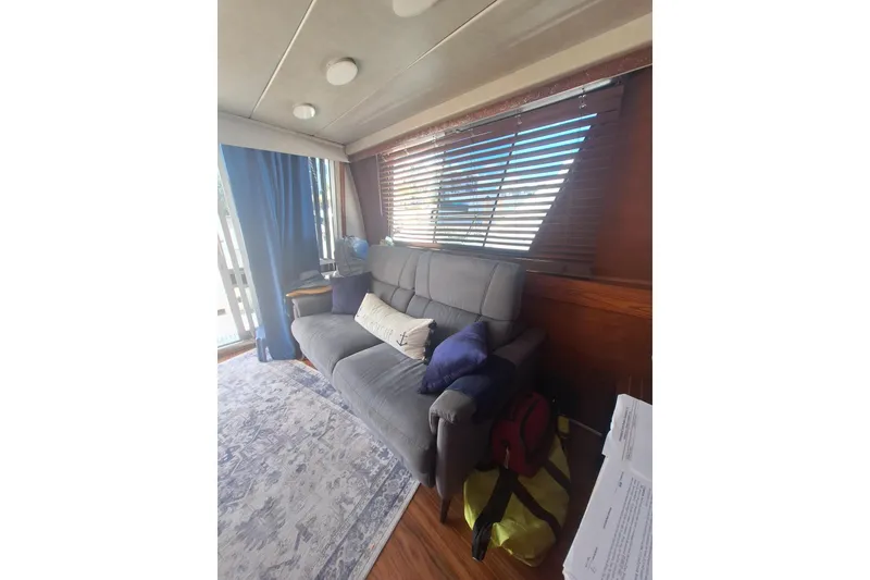 Slide: The Image of Cozy interior of 1988 Birchwood 44TS with sofa, cushions, and window blinds. - 22