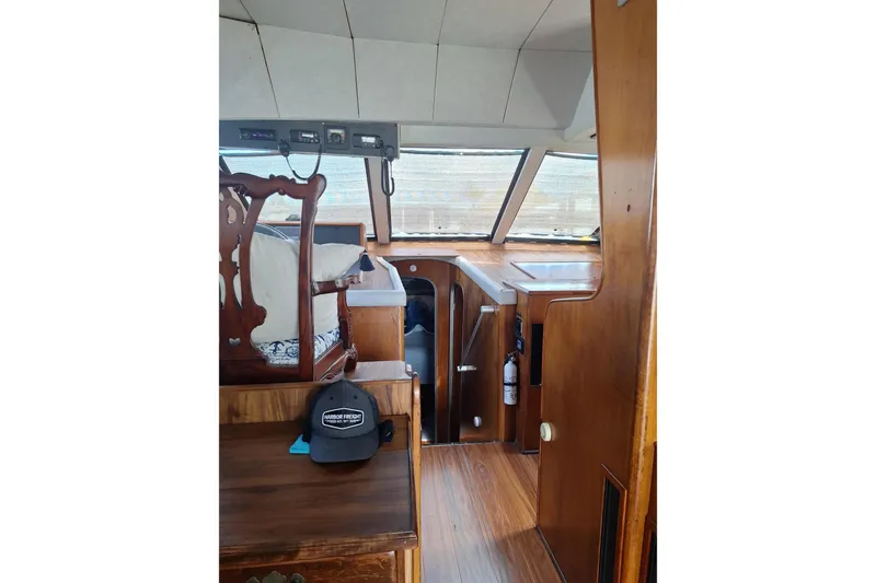 Slide: The Image of Interior of a 1988 Birchwood 44TS boat with wooden furnishings and helm station. - 42