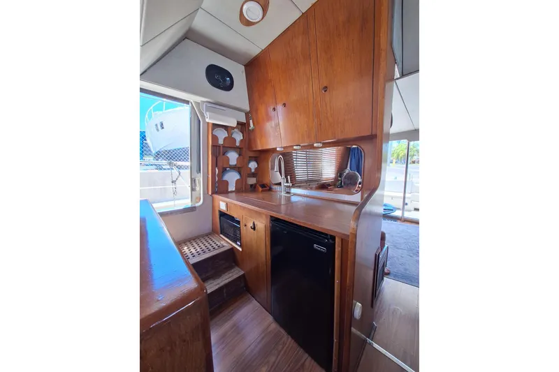 Slide: The Image of Interior of 1988 Birchwood 44TS yacht with wooden cabinetry and compact kitchen area. - 35