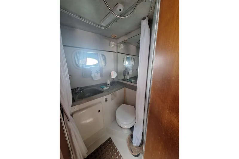 Slide: The Image of Compact bathroom in 1988 Birchwood 44TS boat with sink, toilet, and mirror. - 32