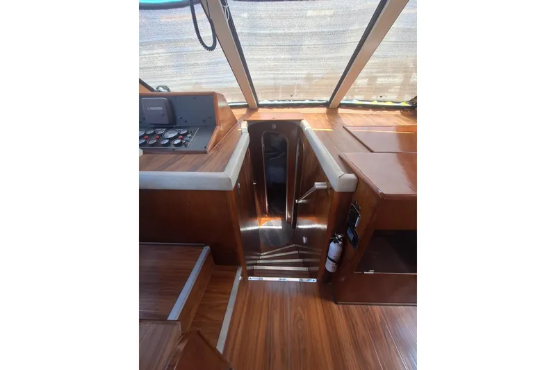 Slide: The Image of Interior of 1988 Birchwood 44TS yacht with polished wood finish and control panel. - 28
