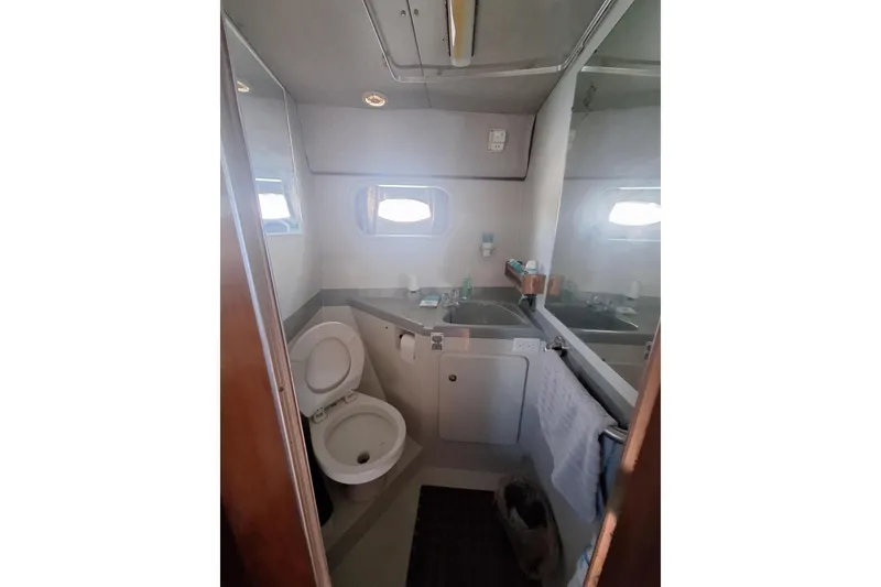 Slide: The Image of Bathroom interior of 1988 Birchwood 44TS yacht, featuring toilet, sink, and mirror. - 31