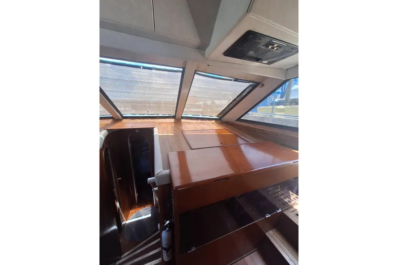 Slide: The Image of Interior view of 1988 Birchwood 44TS boat with wooden finishes and large windows. - 18