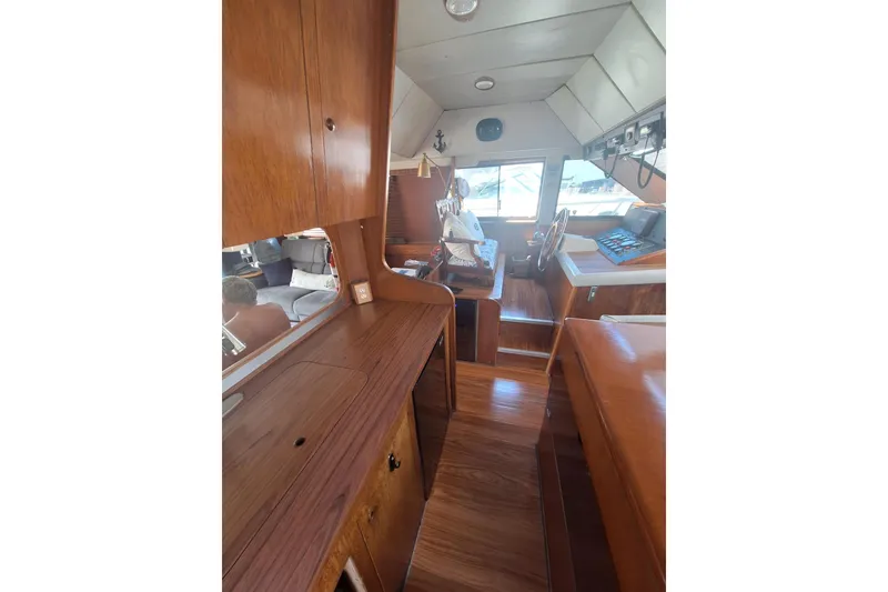 Slide: The Image of Interior of a 1988 Birchwood 44TS boat with wooden cabinetry and helm station. - 20